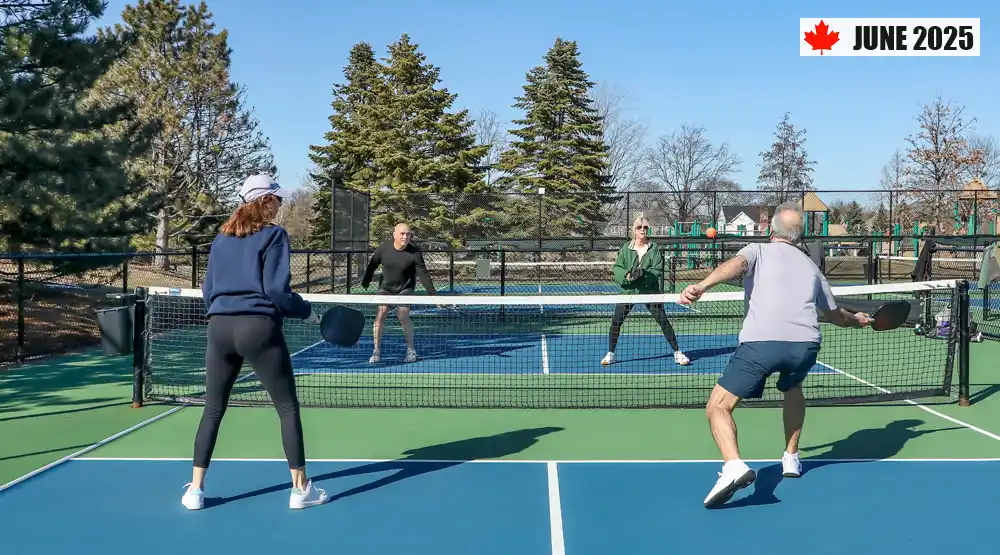 Four adults playing doubles pickleball on an outdoor court in Canada. Banner with maple leaf reading June 2025