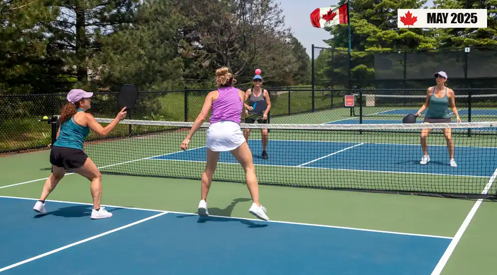 Players enjoying a competitive game of pickleball on an outdoor court in Canada during spring 2025.