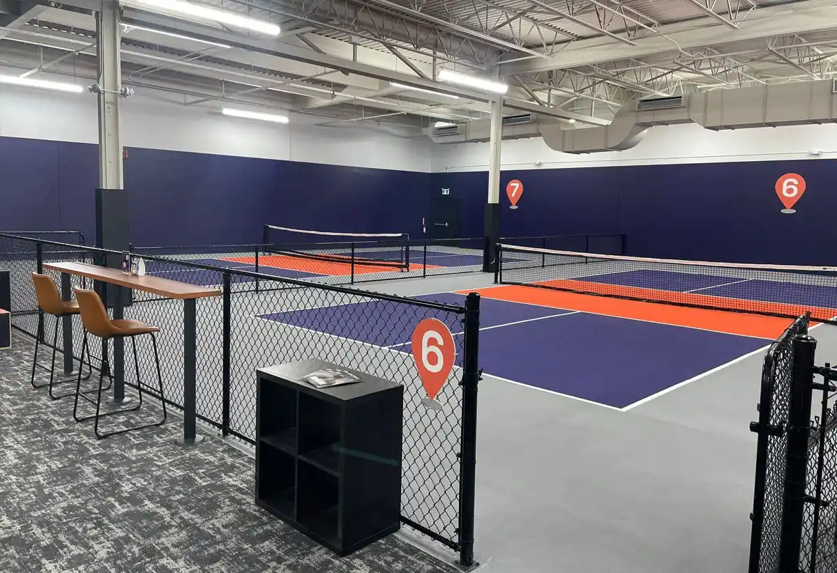 Indoor pickleball courts at Pickleplex, featuring custom surfacing by TSS Pickleball, Official Court Supplier for Pickleball Ontario