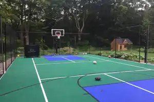 <p>A vibrant 30x60 backyard court installation with modular SnapSports® tiles in green and bold blue key zones. Perfect for basketball, pickleball, and more—all set in a private wooded retreat.</p>