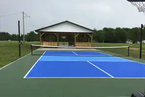 A crisp blue-and-green court set on SnapSports tiles against a rural Manitoba backdrop. Perfect for community recreation.