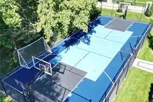This expansive backyard multi-game court in Markham, Ontario, is a dream for active families. It expertly combines a pickleball court, basketball hoops, and a soccer net, offering a comprehensive and dynamic space for a wide array of sports and endless fun.